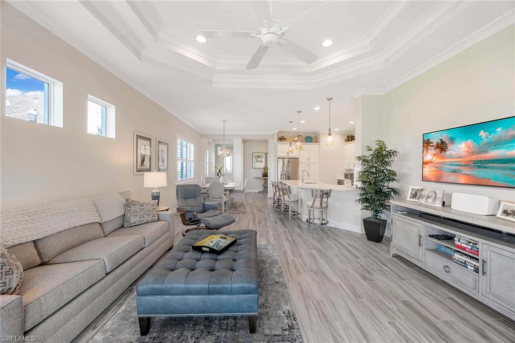 5626 Elbow Avenue Naples, FL 34113 - Photo 11 of 48 a living room with furniture and a flat screen tv