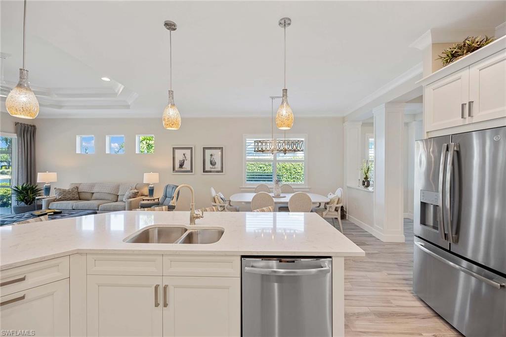 5626 Elbow Avenue Naples, FL 34113 - Photo 15 of 48 a kitchen with a sink a counter space appliances and cabinets