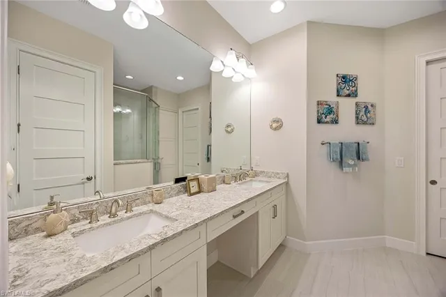 a bathroom with a granite countertop sink mirror and double