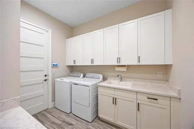 a view of a storage and utility room with closet dryer and washer