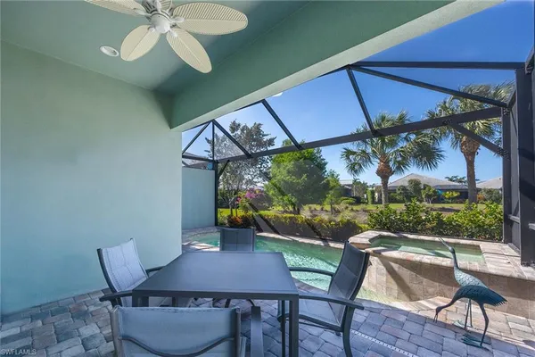 a view of a patio with table and chairs under an umbrella