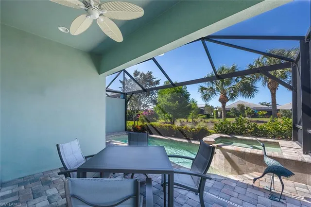 a view of a patio with table and chairs under an umbrella