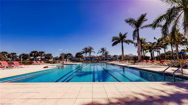 a view of a swimming pool and lounge chairs