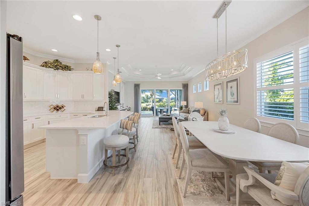 5626 Elbow Avenue Naples, FL 34113 - Photo 6 of 48 a large kitchen with a table and chairs