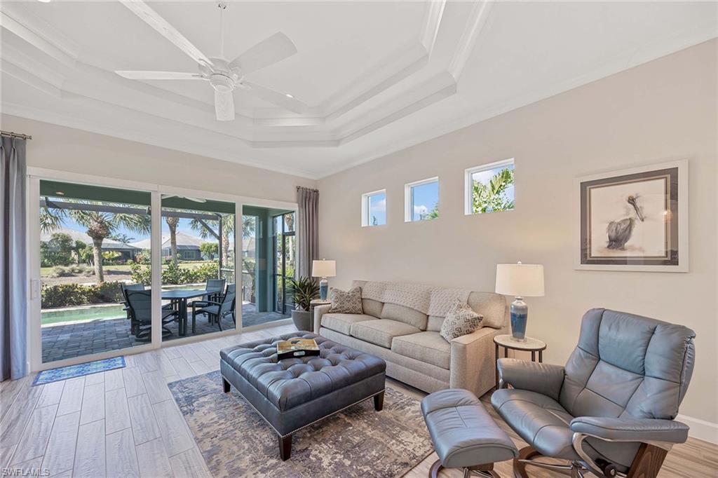 5626 Elbow Avenue Naples, FL 34113 - Photo 7 of 48 a living room with furniture and a wooden floor