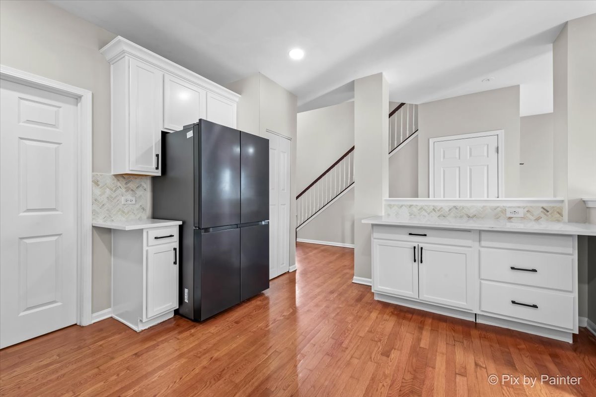 486 Vaughn Circle Aurora, IL 60502 - Photo 11 of 40 a kitchen with a refrigerator and a sink