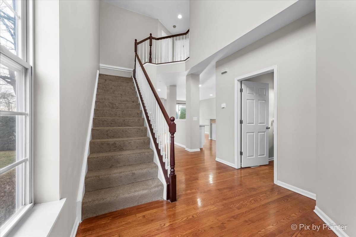 486 Vaughn Circle Aurora, IL 60502 - Photo 12 of 40 a view of staircase with wooden floor and white walls