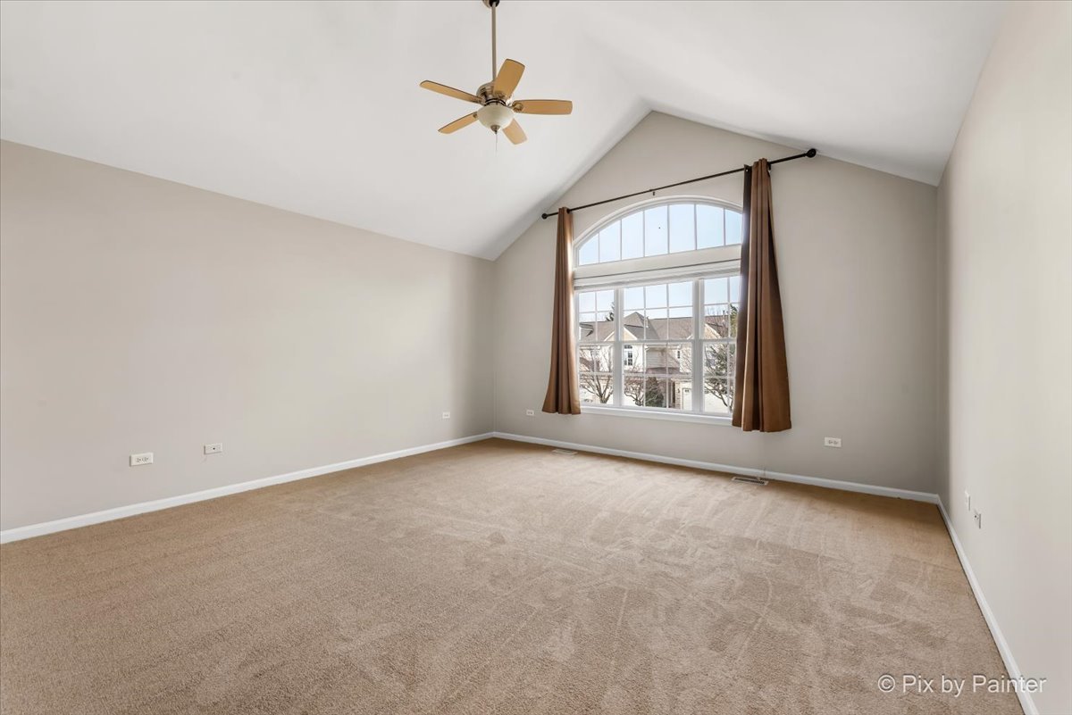 486 Vaughn Circle Aurora, IL 60502 - Photo 15 of 40 an empty room with windows and fan