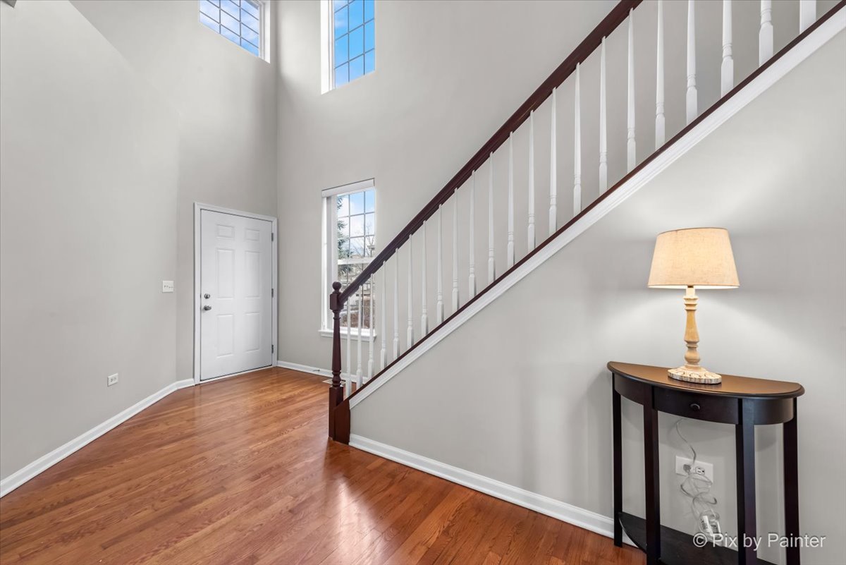 486 Vaughn Circle Aurora, IL 60502 - Photo 2 of 40 a view of entryway and hall with wooden floor