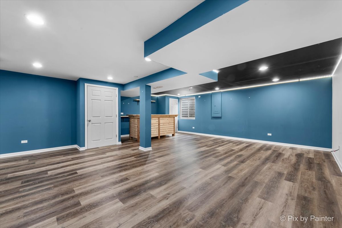 486 Vaughn Circle Aurora, IL 60502 - Photo 27 of 40 a view of an empty room with wooden floor and staircase