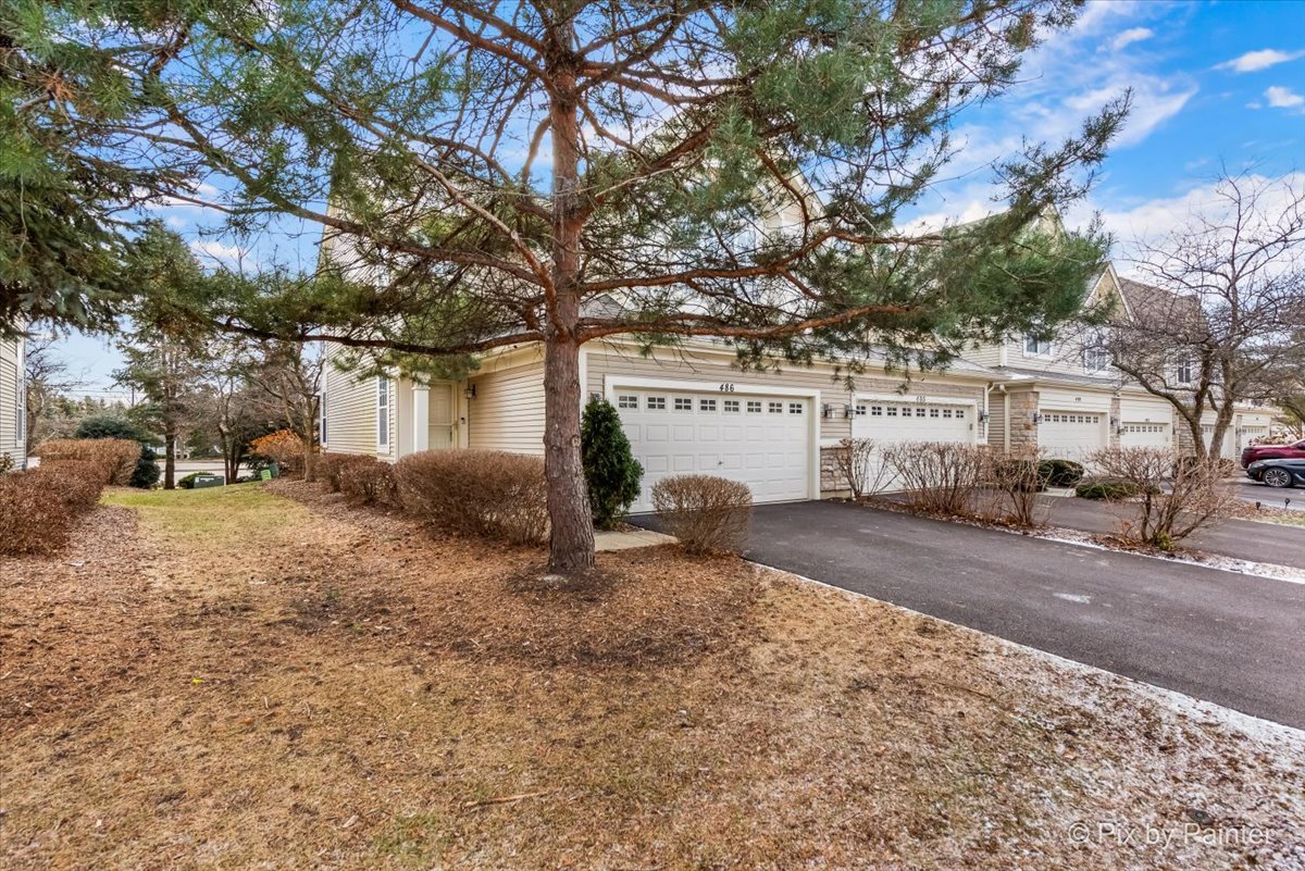 486 Vaughn Circle Aurora, IL 60502 - Photo 30 of 40 a view of a house with a yard