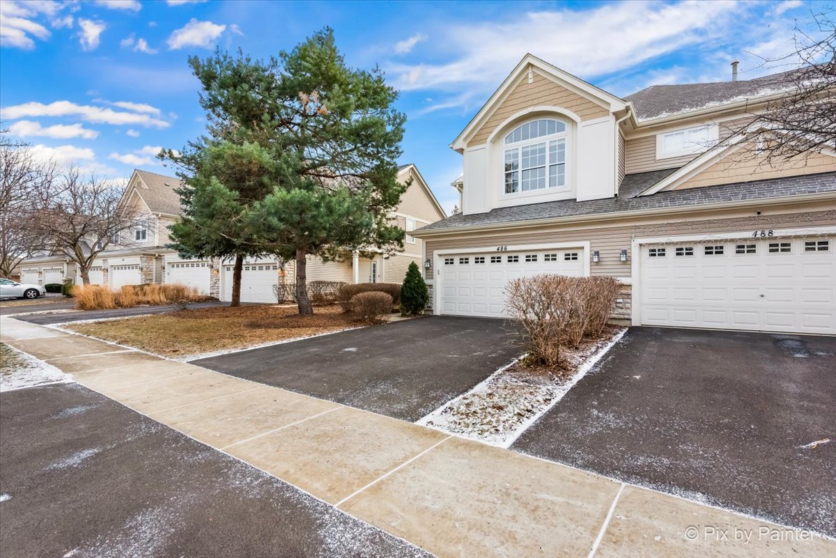 486 Vaughn Circle Aurora, IL 60502 - Photo 31 of 40 a view of a white house with a large tree