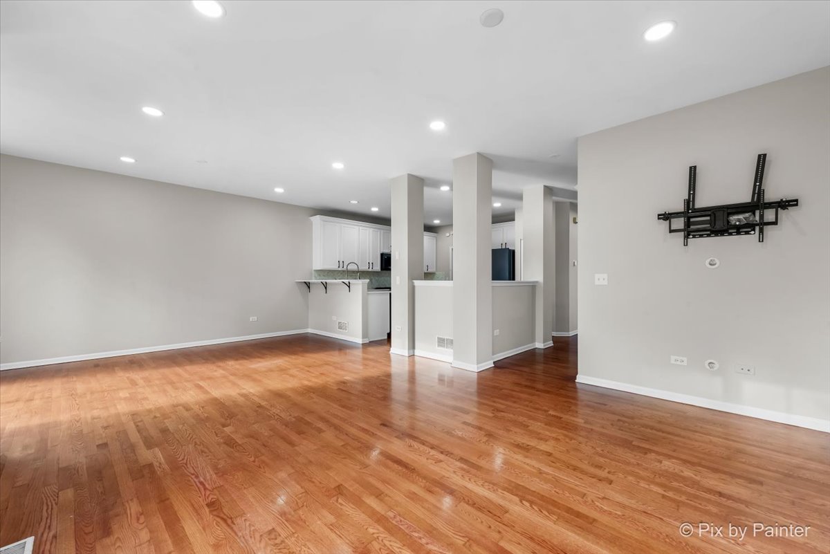 486 Vaughn Circle Aurora, IL 60502 - Photo 5 of 40 a view of a kitchen with a sink and wooden floor