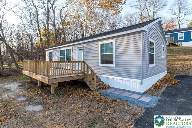a view of a house with a yard and deck