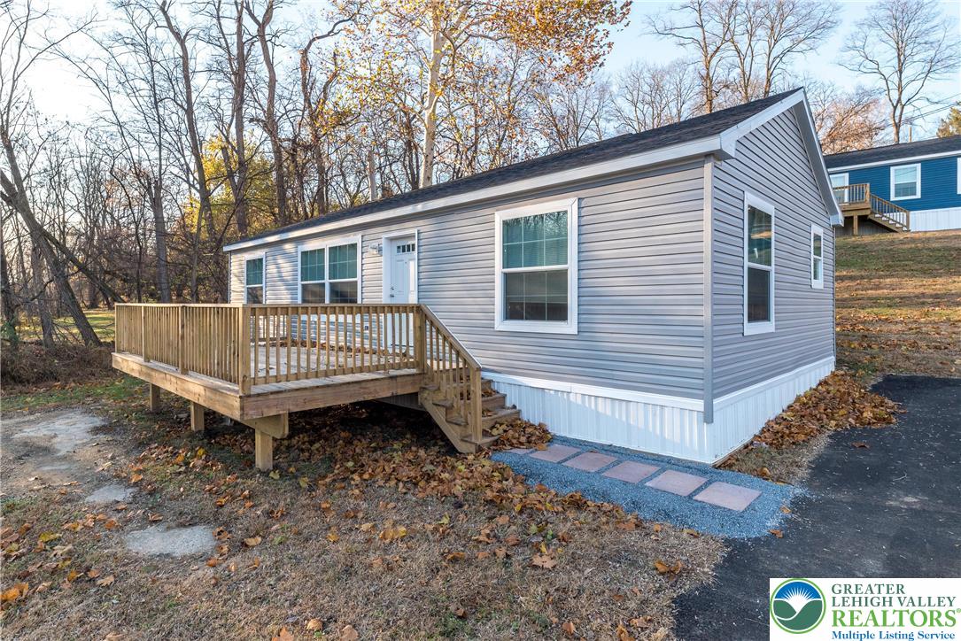 a view of a house with a yard and deck
