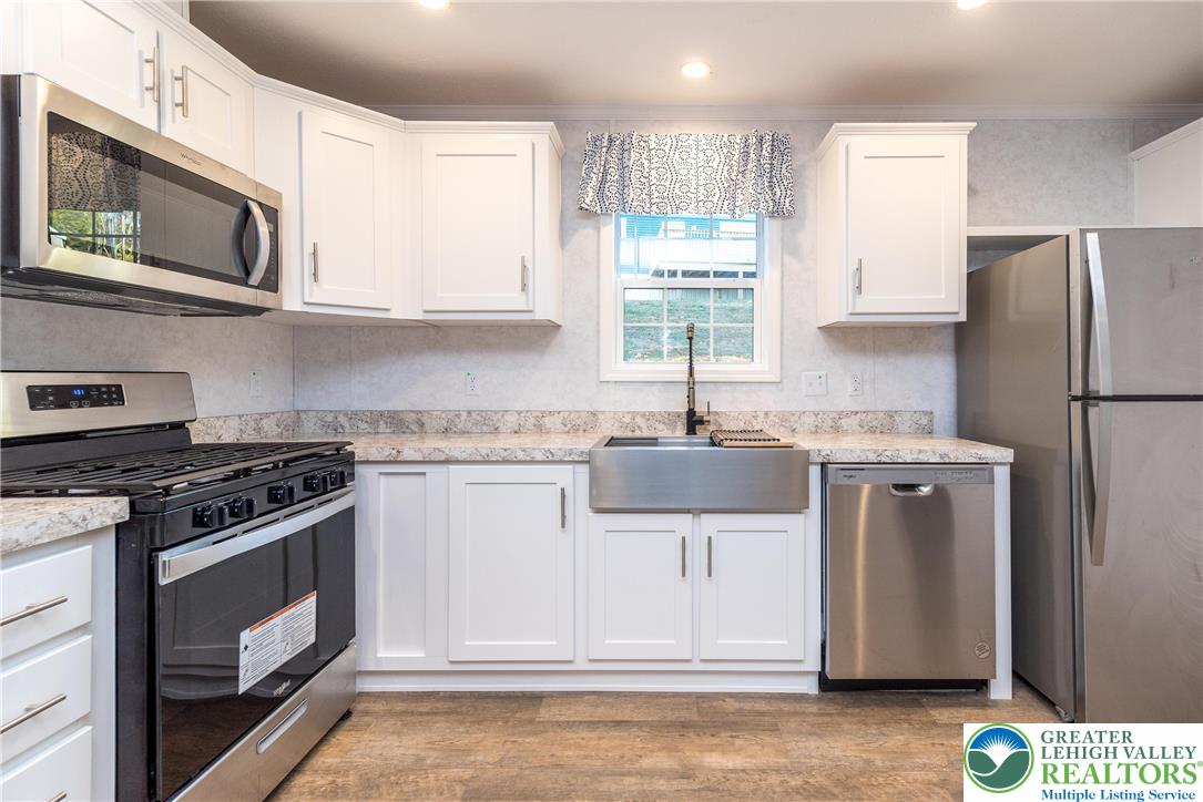 465 Royal Manor Road, Unit LOT 8 Easton, PA 18042 - Photo 4 of 23 a kitchen with stainless steel appliances a stove microwave and refrigerator