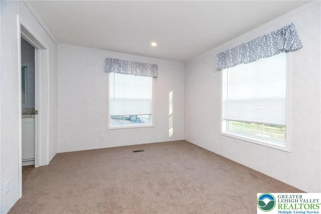 a view of an empty room with a window