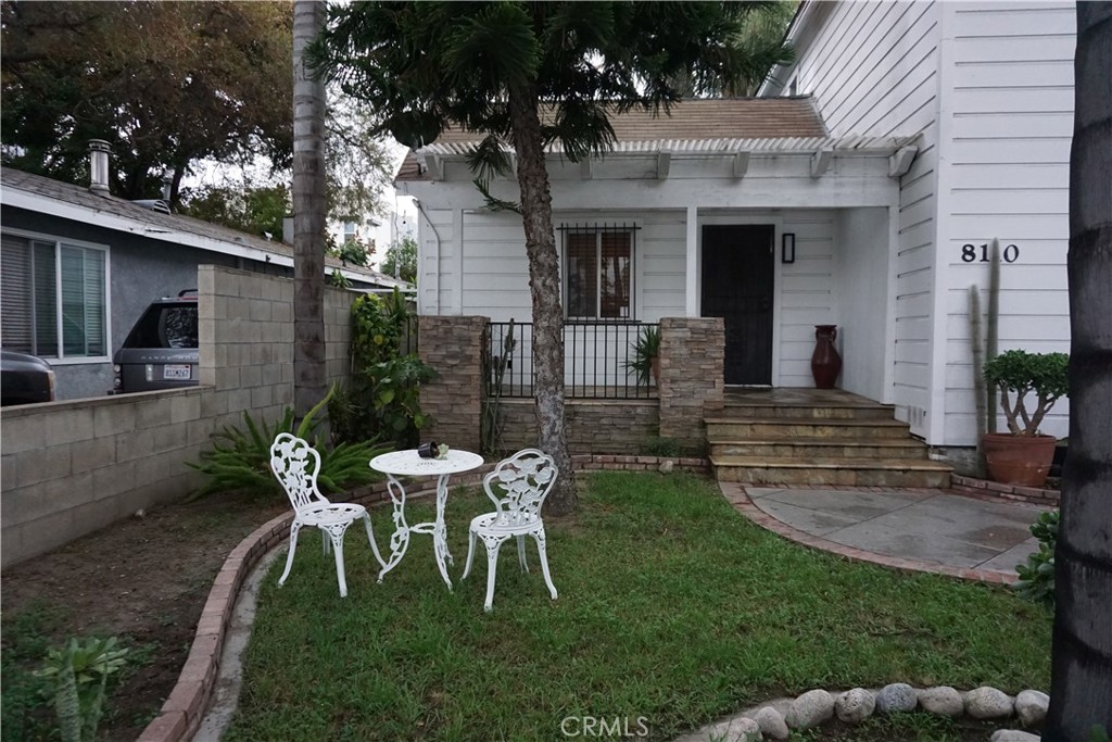 8110 3rd Street Downey, CA 90241 - Photo 4 of 7 a view of a chair and table in backyard of the house