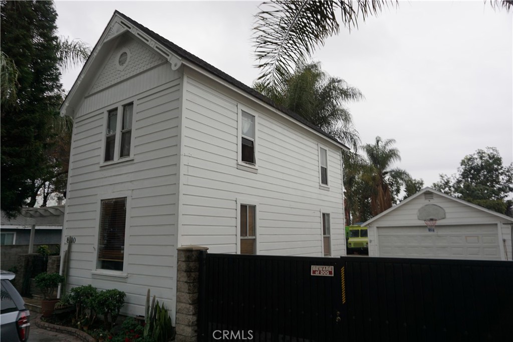 8110 3rd Street Downey, CA 90241 - Photo 6 of 7 a front view of a house with a garden