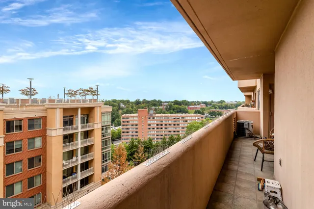 a balcony with furniture and a large window