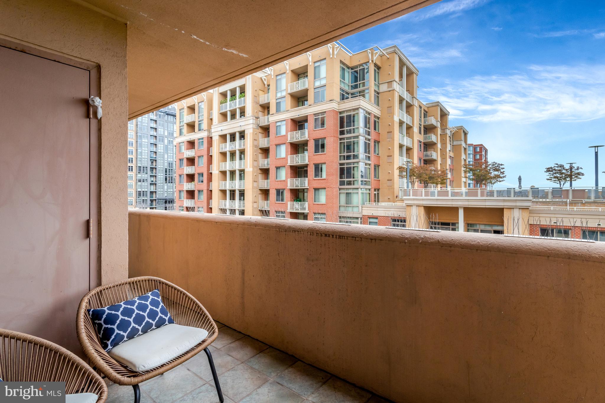 1301 North Courthouse Road, Unit 1108 Arlington, VA 22201 - Photo 16 of 49 a balcony with a bench and a potted plant