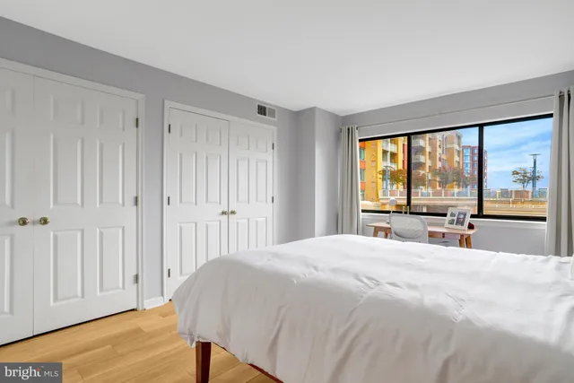 a balcony with a bench and a potted plant