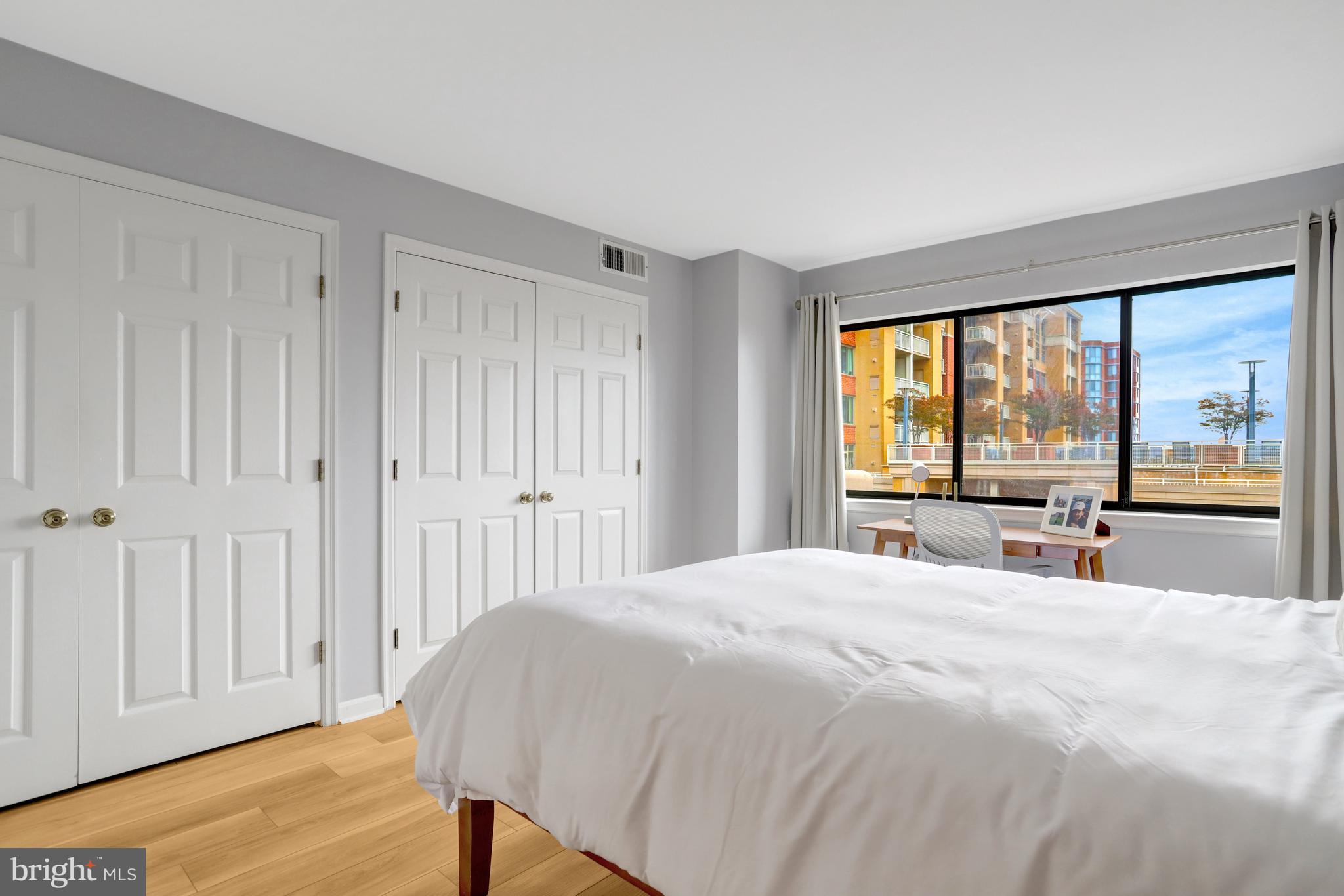 1301 North Courthouse Road, Unit 1108 Arlington, VA 22201 - Photo 17 of 49 a bedroom with a bed and a large window