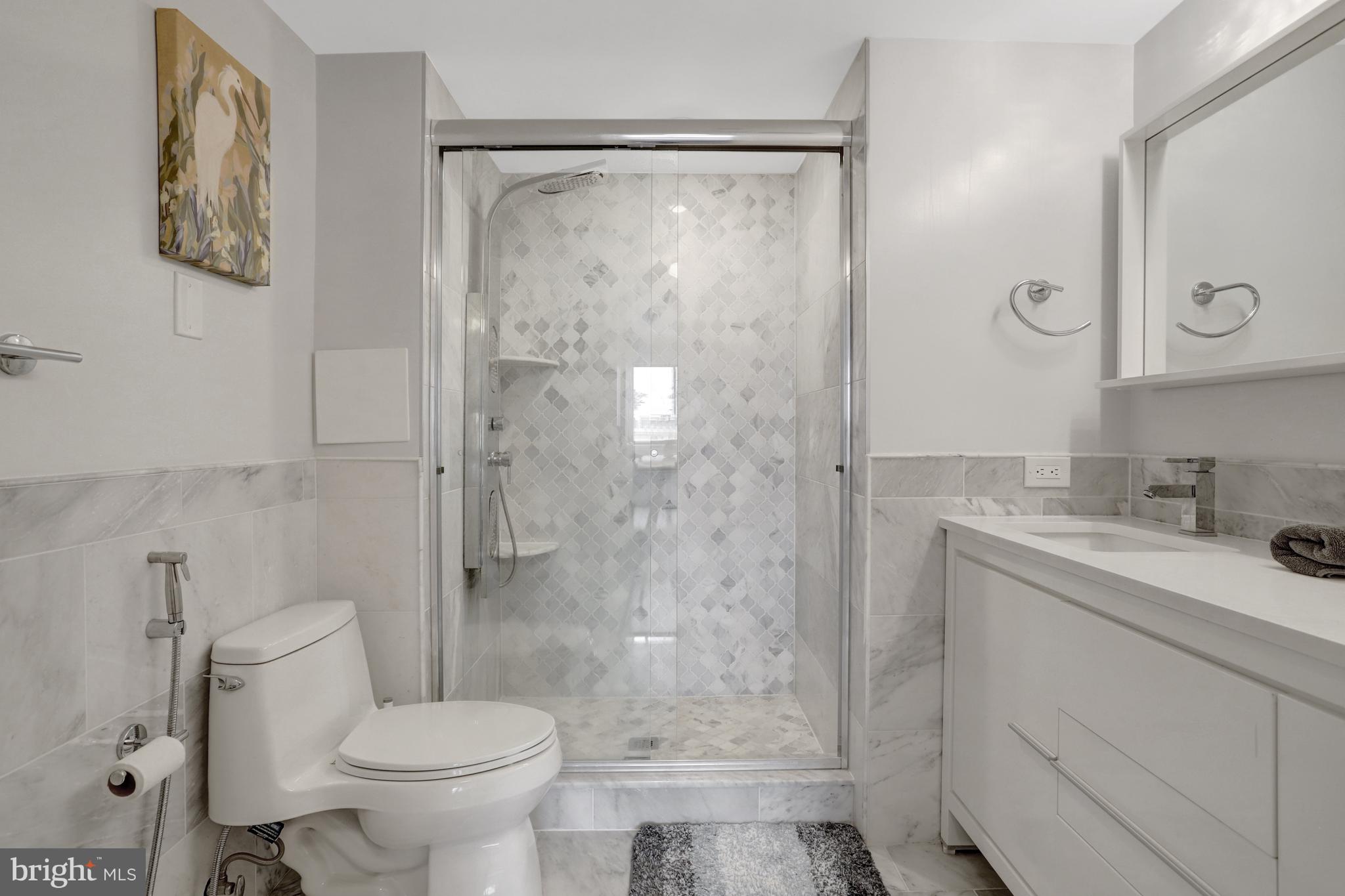 1301 North Courthouse Road, Unit 1108 Arlington, VA 22201 - Photo 19 of 49 a bathroom with a granite countertop sink toilet and shower