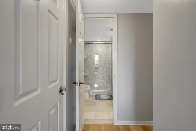 a bathroom with a granite countertop sink a mirror a shower and a mirror