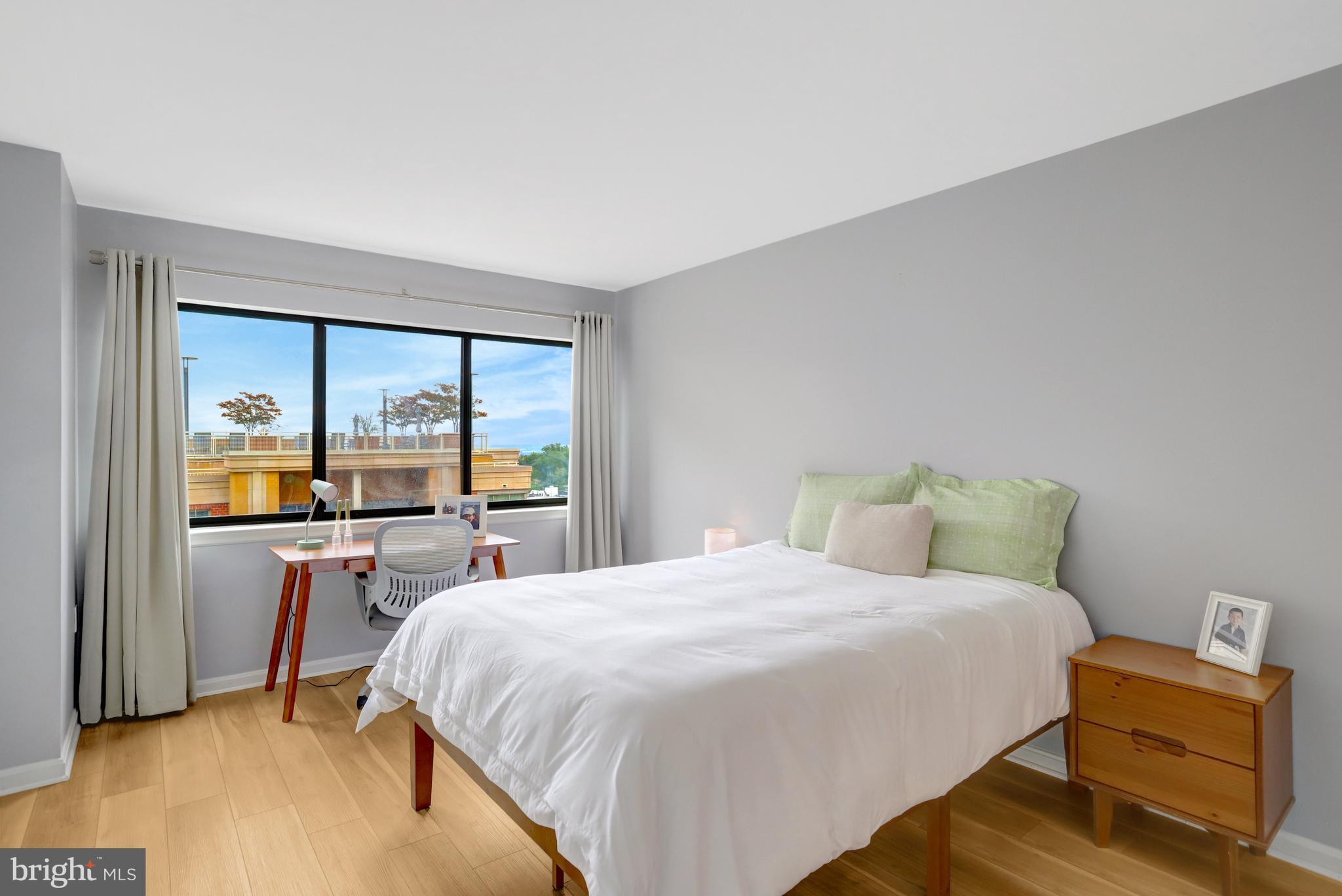 1301 North Courthouse Road, Unit 1108 Arlington, VA 22201 - Photo 22 of 49 a bedroom with a bed and a large window