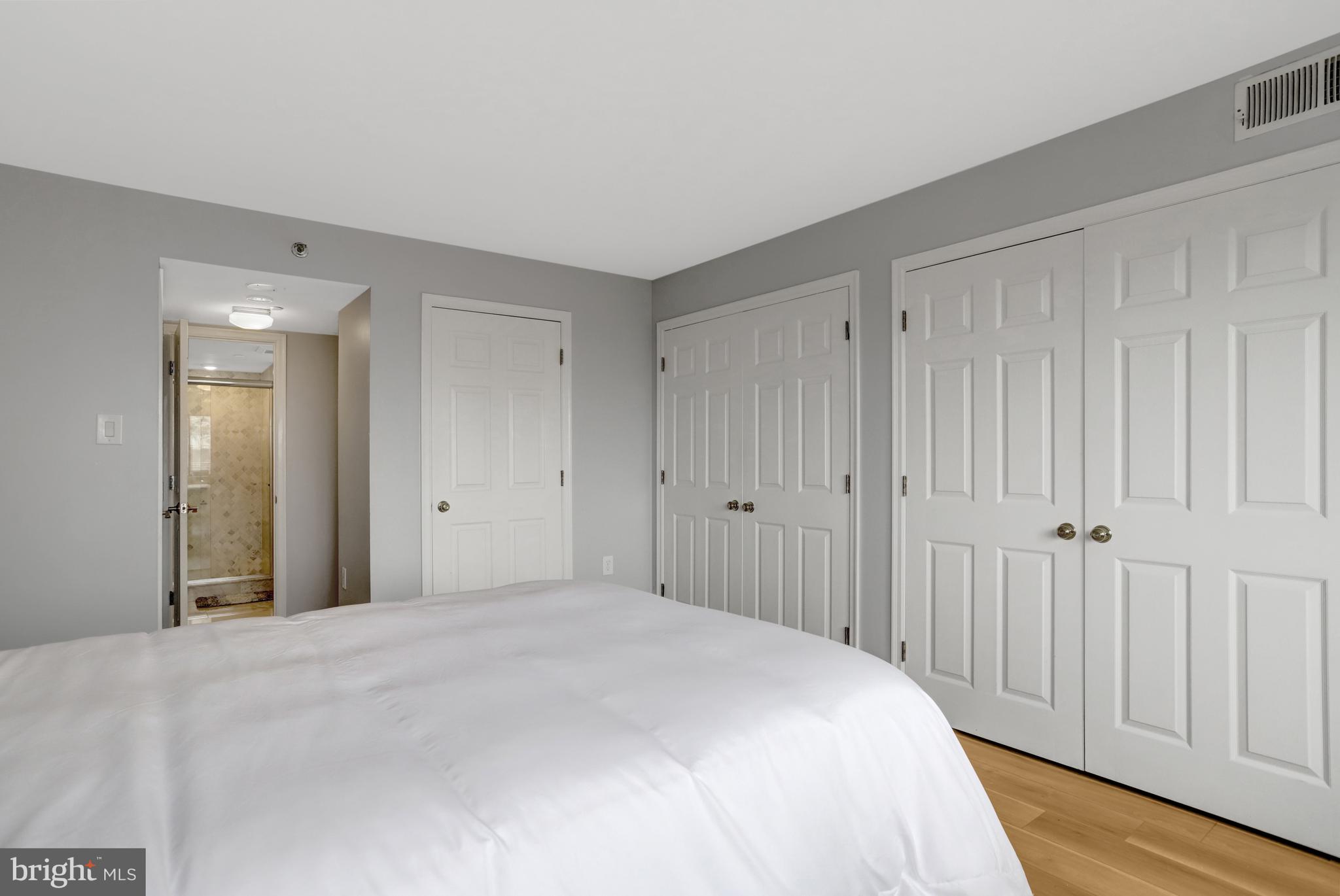 1301 North Courthouse Road, Unit 1108 Arlington, VA 22201 - Photo 23 of 49 a bedroom with a bed and wooden floor