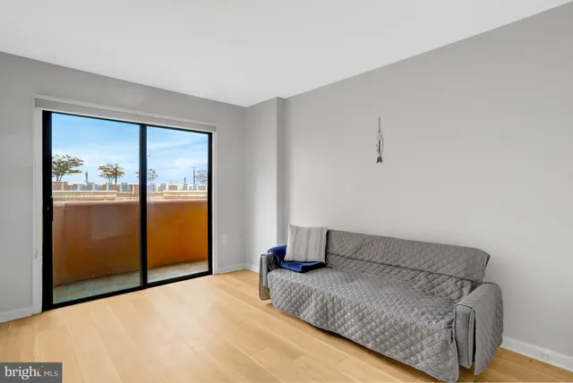 a view of a kitchen with a sink a refrigerator and wooden floor