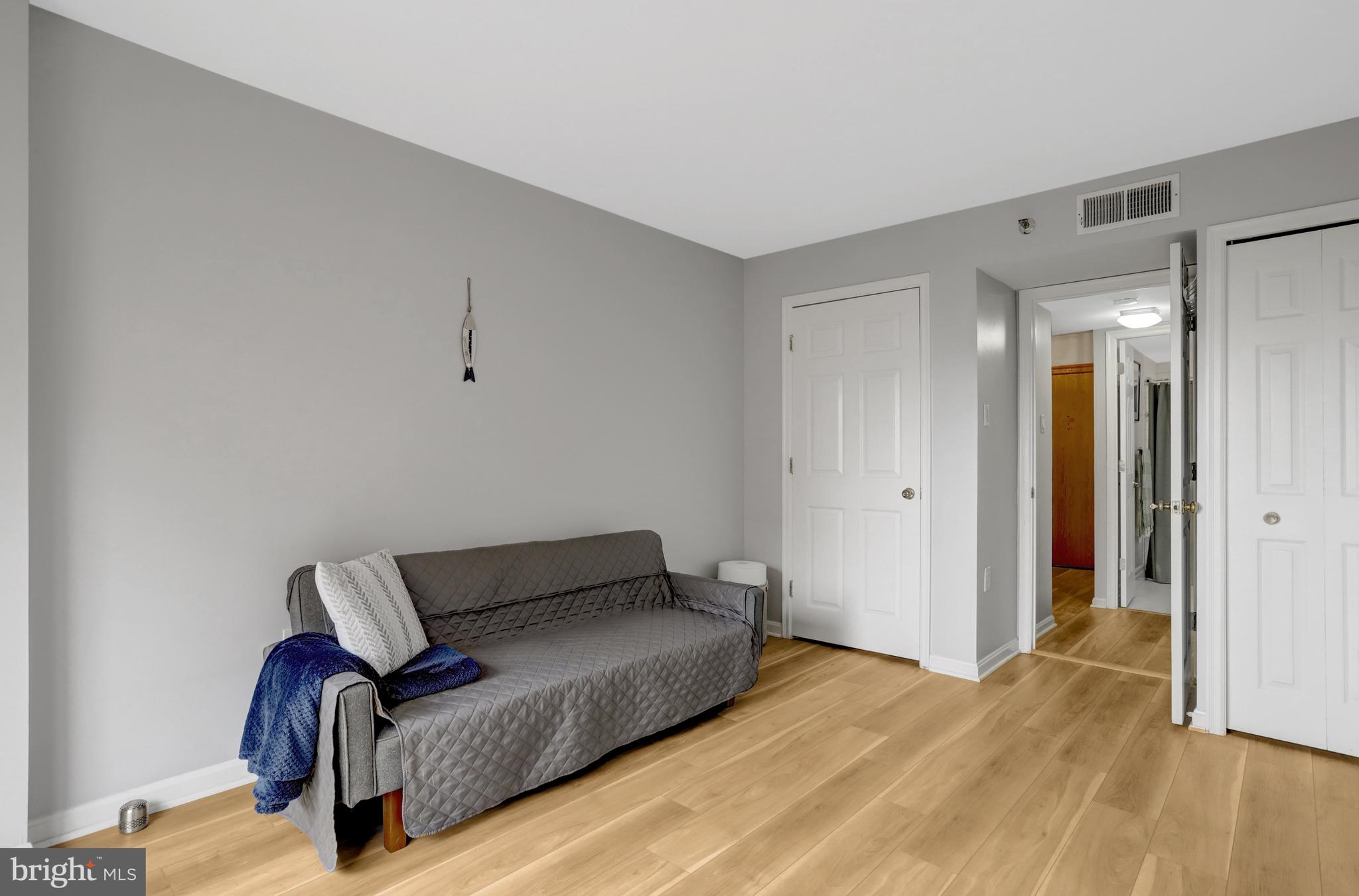 1301 North Courthouse Road, Unit 1108 Arlington, VA 22201 - Photo 28 of 49 a bedroom with a bed and wooden floor