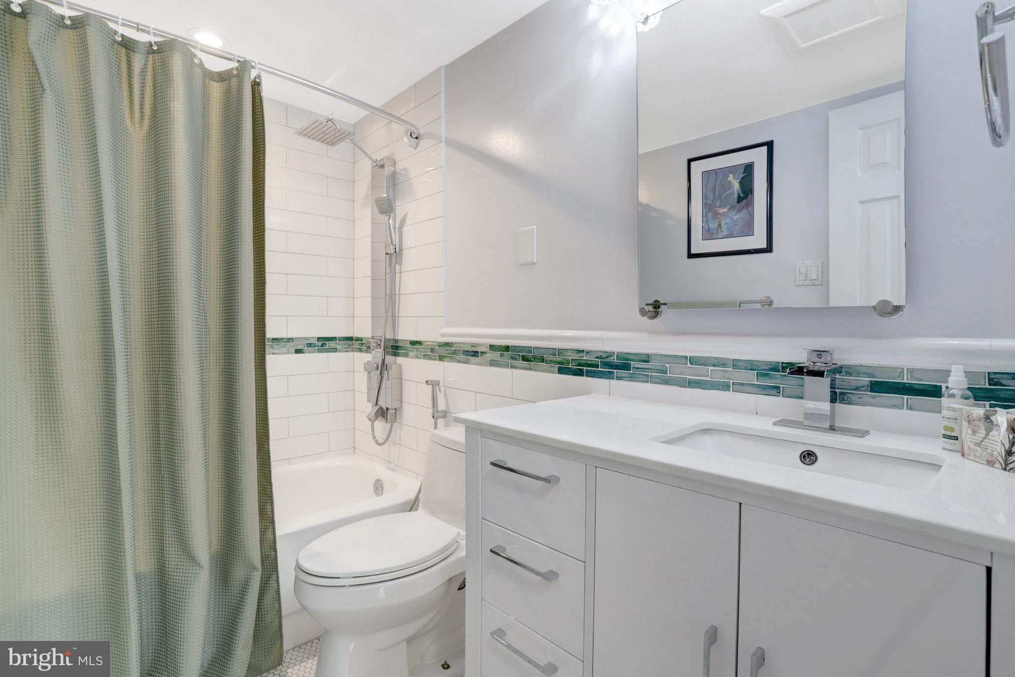 1301 North Courthouse Road, Unit 1108 Arlington, VA 22201 - Photo 30 of 49 a bathroom with a sink a toilet and shower