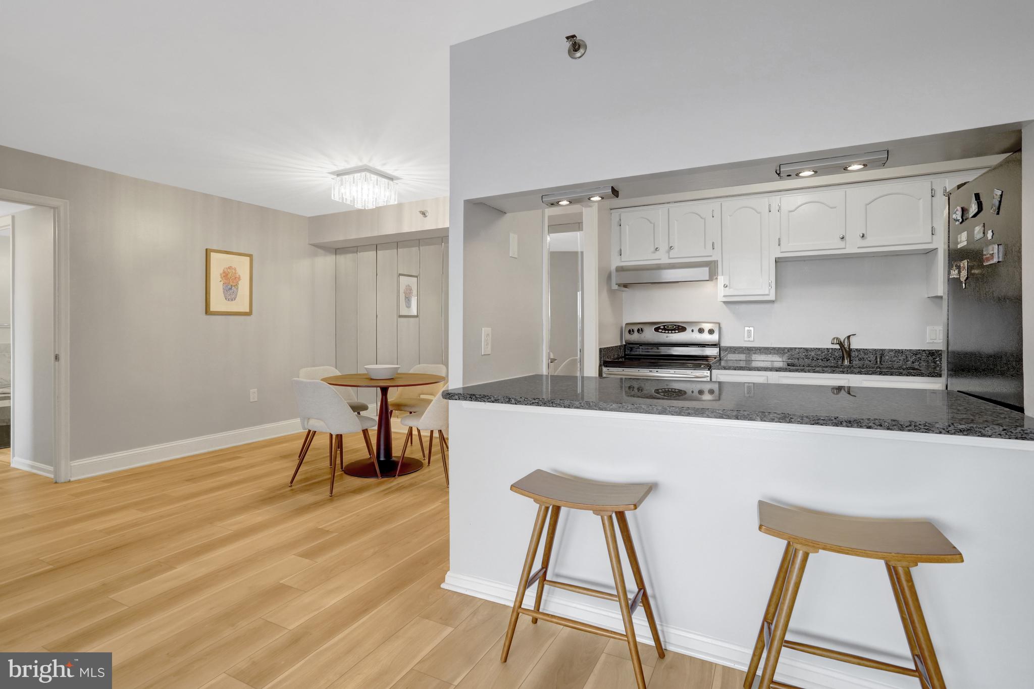 1301 North Courthouse Road, Unit 1108 Arlington, VA 22201 - Photo 7 of 49 a kitchen with stainless steel appliances granite countertop a stove top oven a sink and cabinets