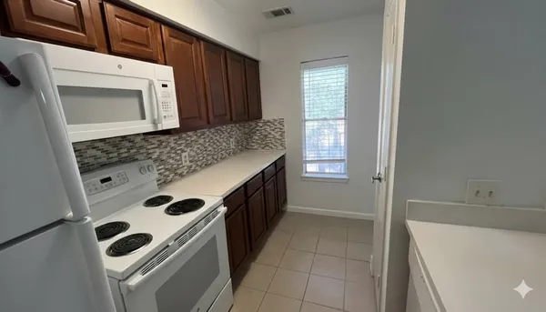 a kitchen with a stove and a microwave