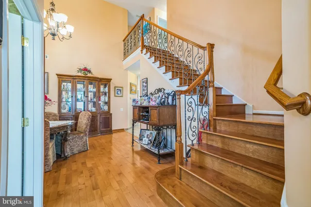 a view of entryway livingroom and hall with wooden floor