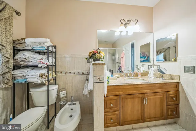 a spacious bathroom with a toilet sink and mirror