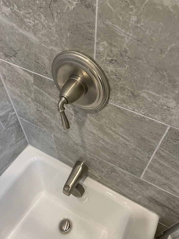 217 Washington Street, Unit 7 Lynn, MA 01902 - Photo 14 of 16 a bathroom with a shower