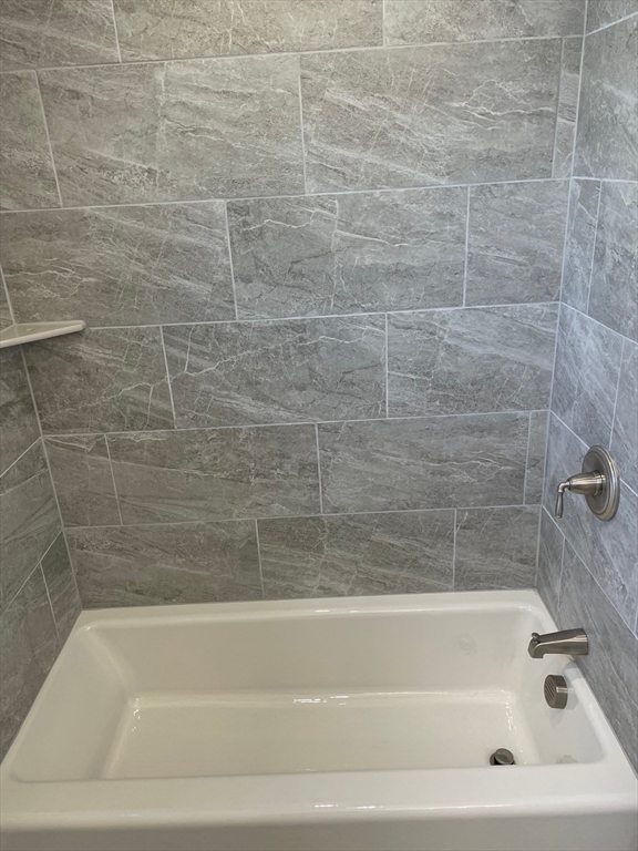 217 Washington Street, Unit 7 Lynn, MA 01902 - Photo 15 of 16 a bathroom with a shower and a bathtub
