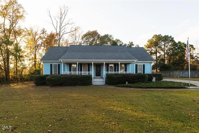 a view of house with yard and green space