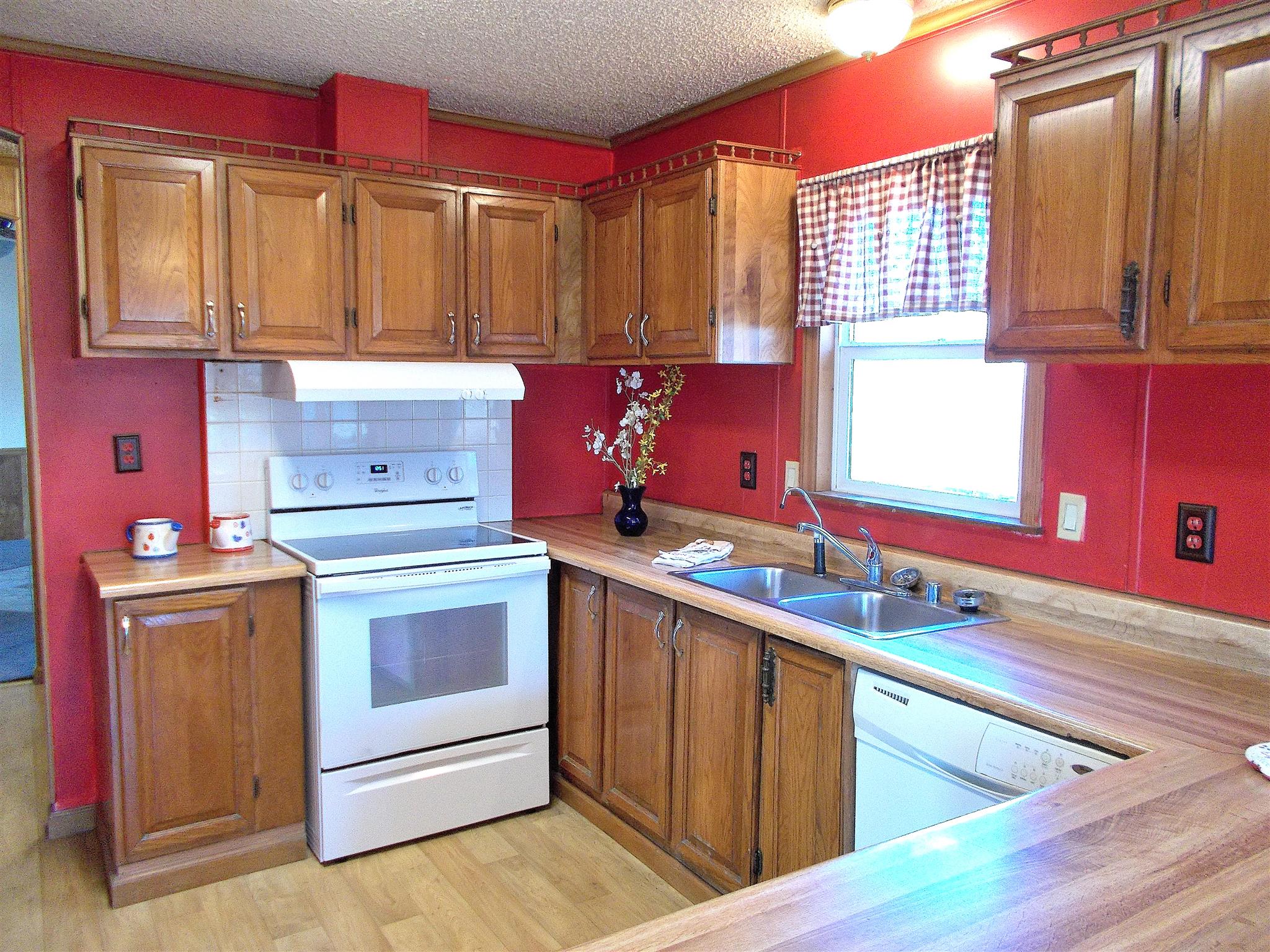 166 Duke Road Dickson, TN 37055 - Photo 11 of 25 a kitchen with stainless steel appliances granite countertop a sink stove and cabinets