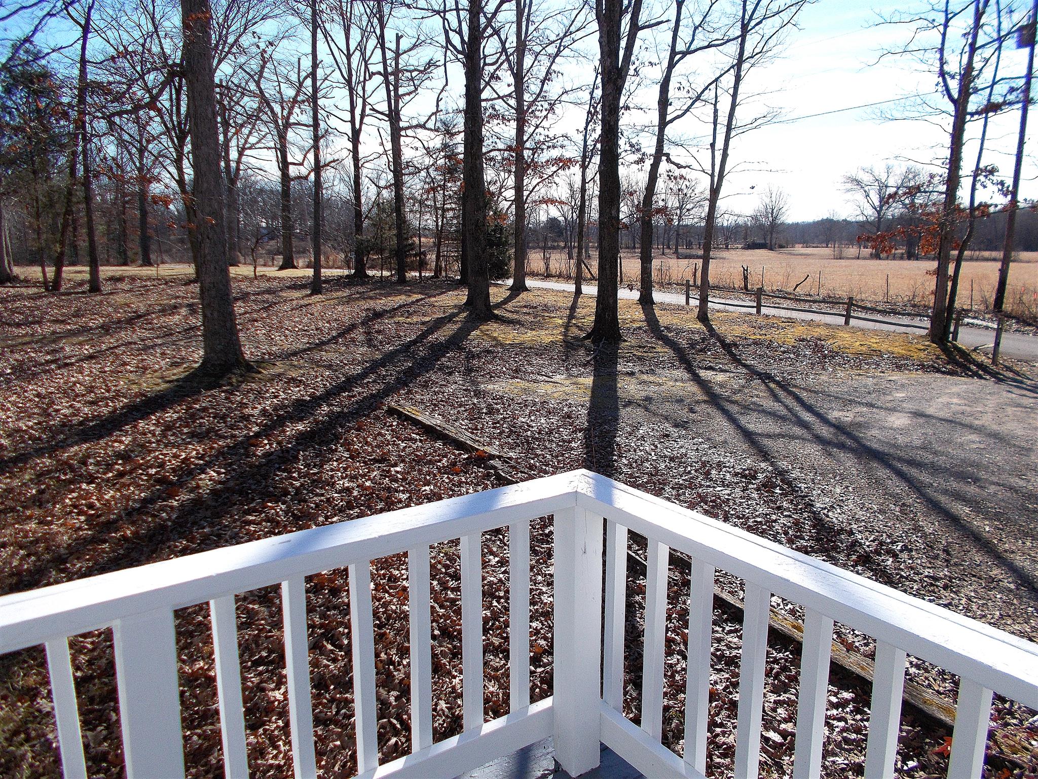 166 Duke Road Dickson, TN 37055 - Photo 6 of 25 a view of a yard with trees and wooden fence