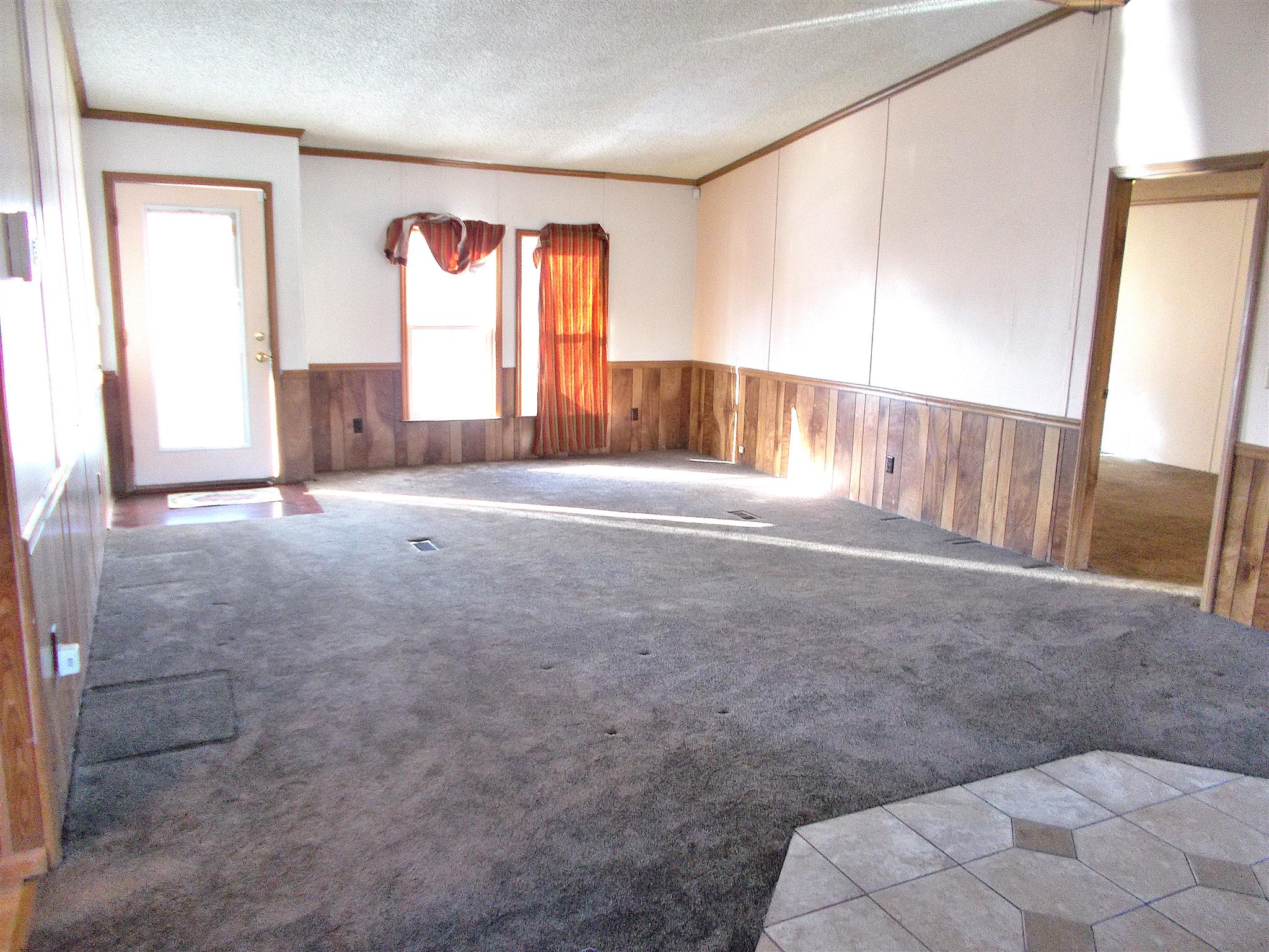 166 Duke Road Dickson, TN 37055 - Photo 9 of 25 a view of an empty room with a fireplace and a window