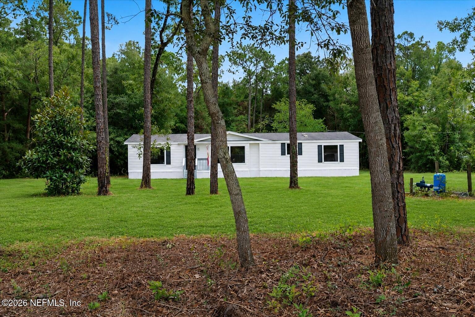 85110 Theresa Road Yulee, FL 32097 - Photo 16 of 43 18_Updated_Lot_View_Through_Trees