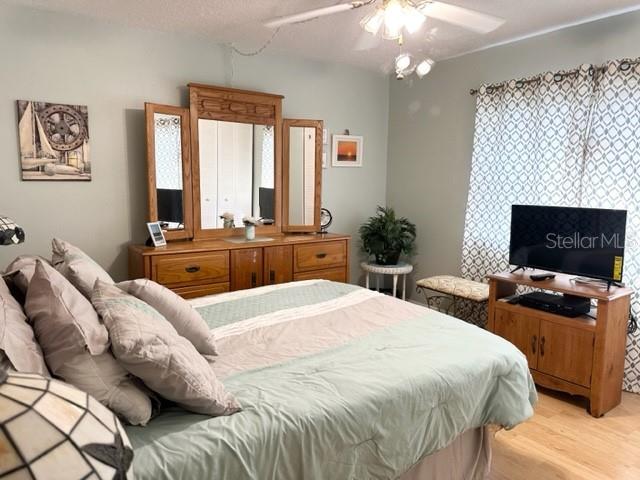 7701 Starkey Road, Unit 731 Seminole, FL 33777 - Photo 9 of 19 a bedroom with a bed and a flat screen tv