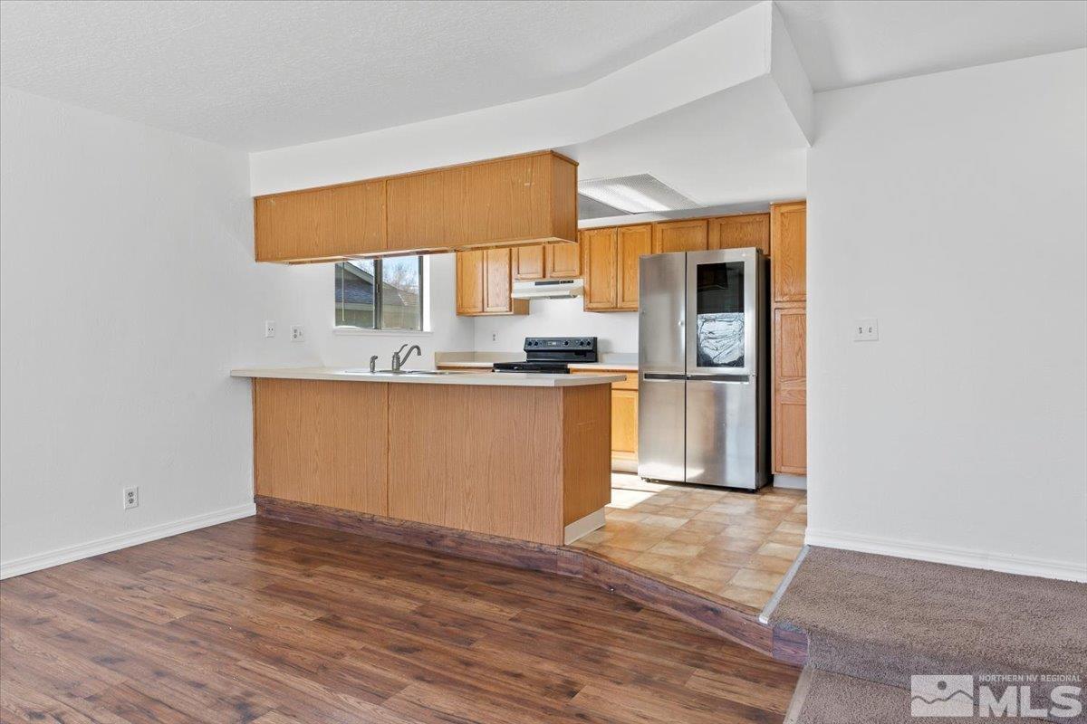 550 Ferol Way Reno, NV 89503 - Photo 9 of 34 a kitchen with stainless steel appliances granite countertop a sink cabinets and wooden floor