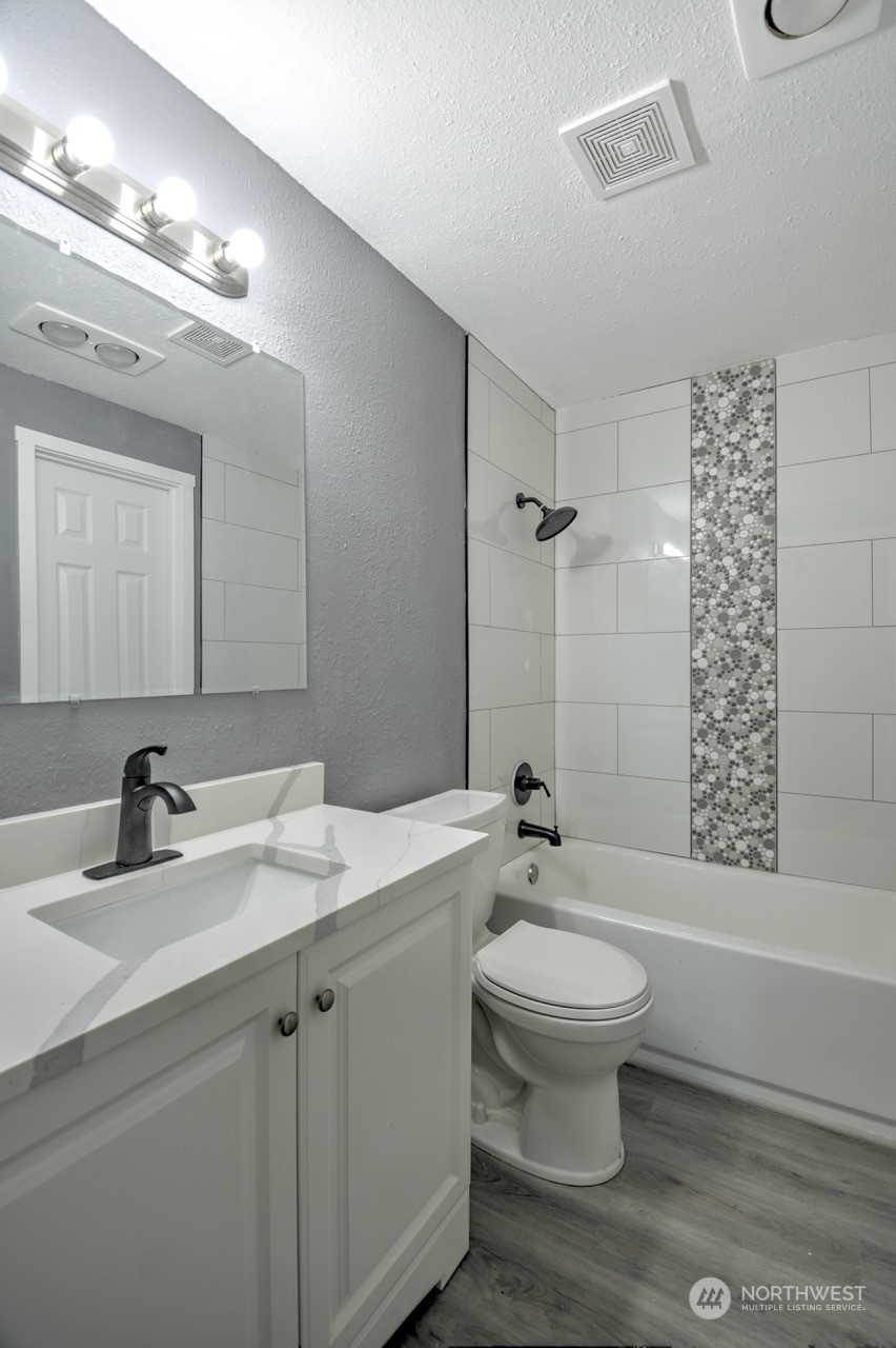 3583 East R Street Tacoma, WA 98404 - Photo 16 of 29 a bathroom with a sink a toilet a mirror and shower