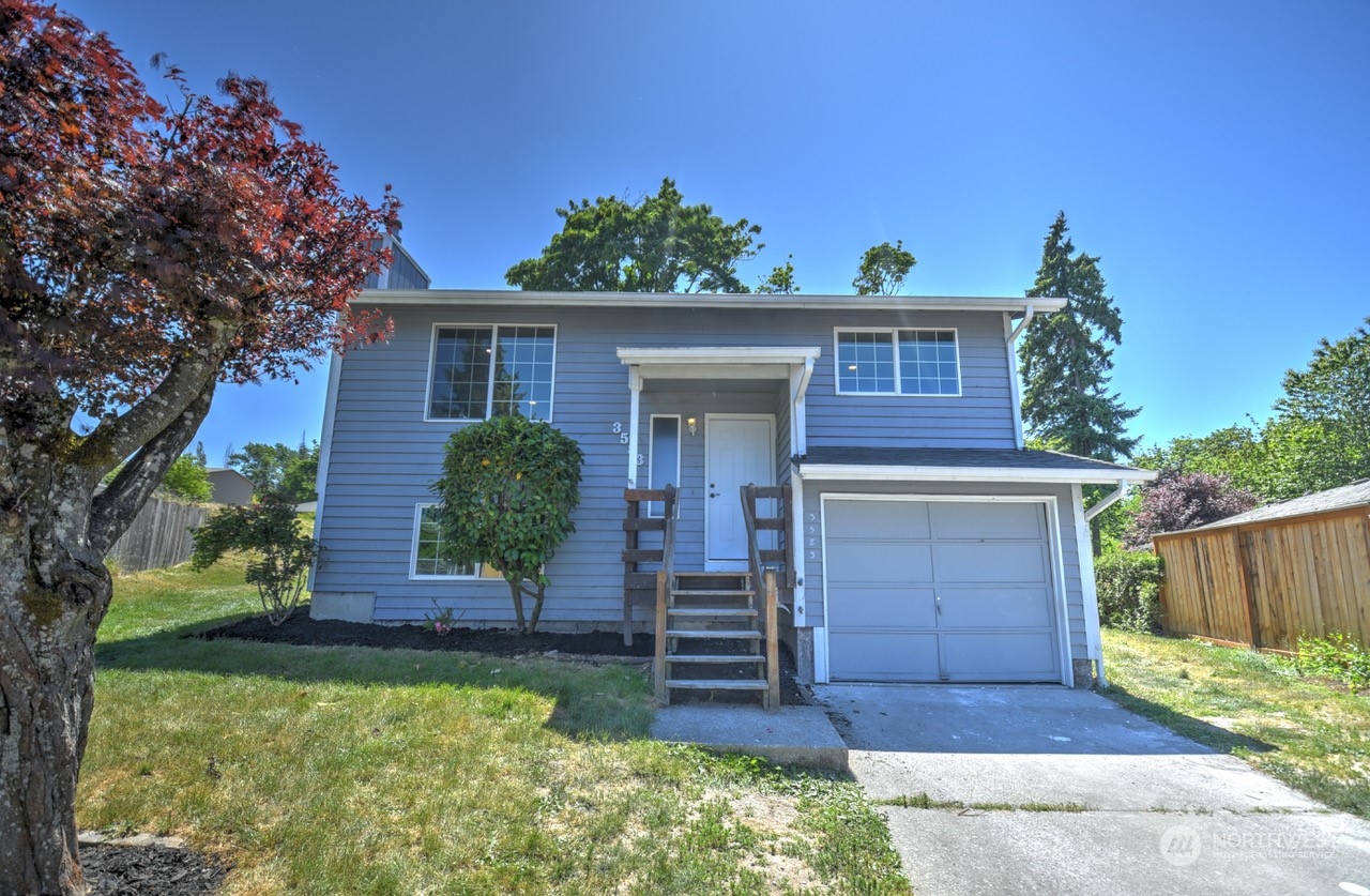 3583 East R Street Tacoma, WA 98404 - Photo 2 of 29 a front view of a house with a yard