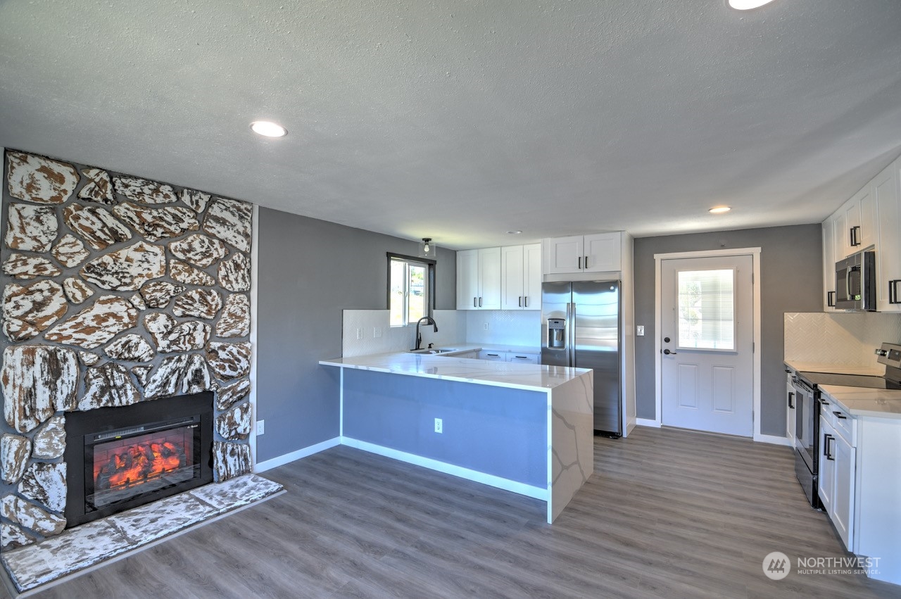 3583 East R Street Tacoma, WA 98404 - Photo 3 of 29 a view of kitchen with furniture and fireplace